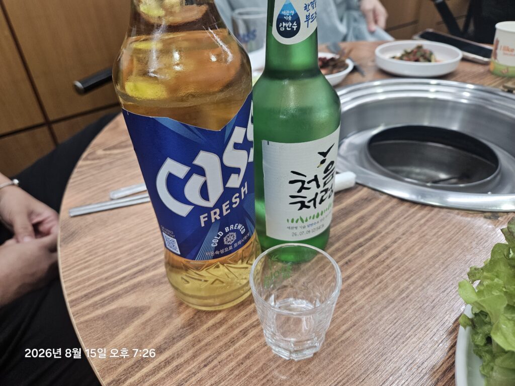 Bottle of soju and drinking glasses at a Korean BBQ dinner