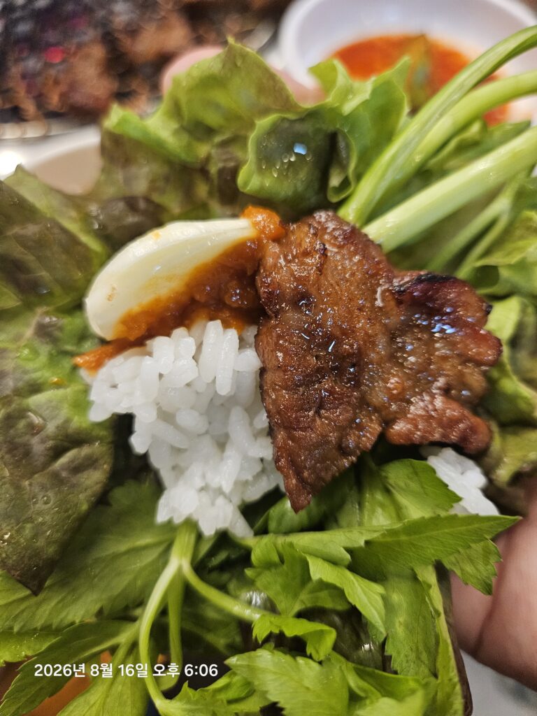 Korean ssam with grilled pork rice garlic and fresh vegetables